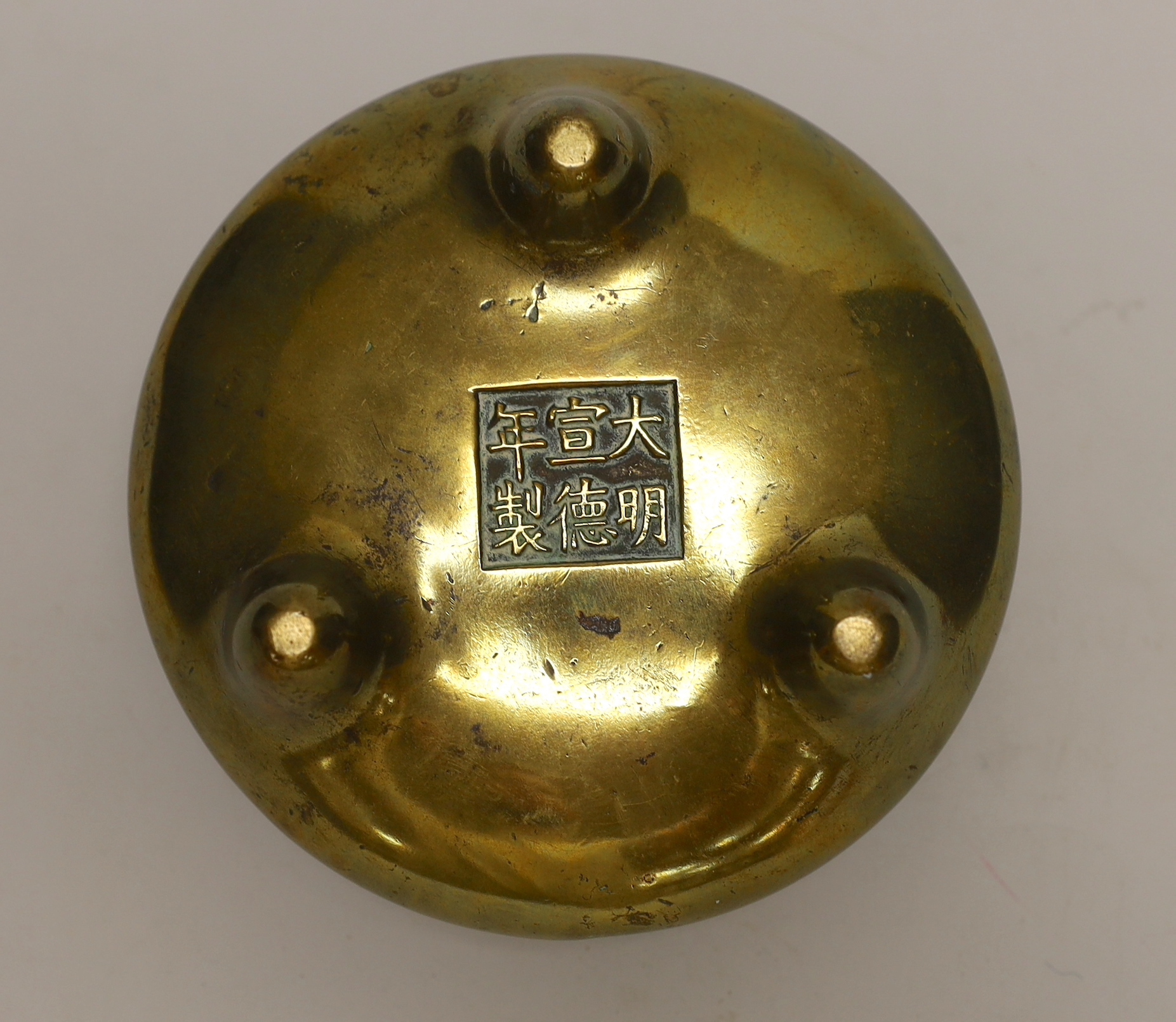 A Chinese bronze tripod censer, ding, Xuande mark but 19th century, 13cm wide